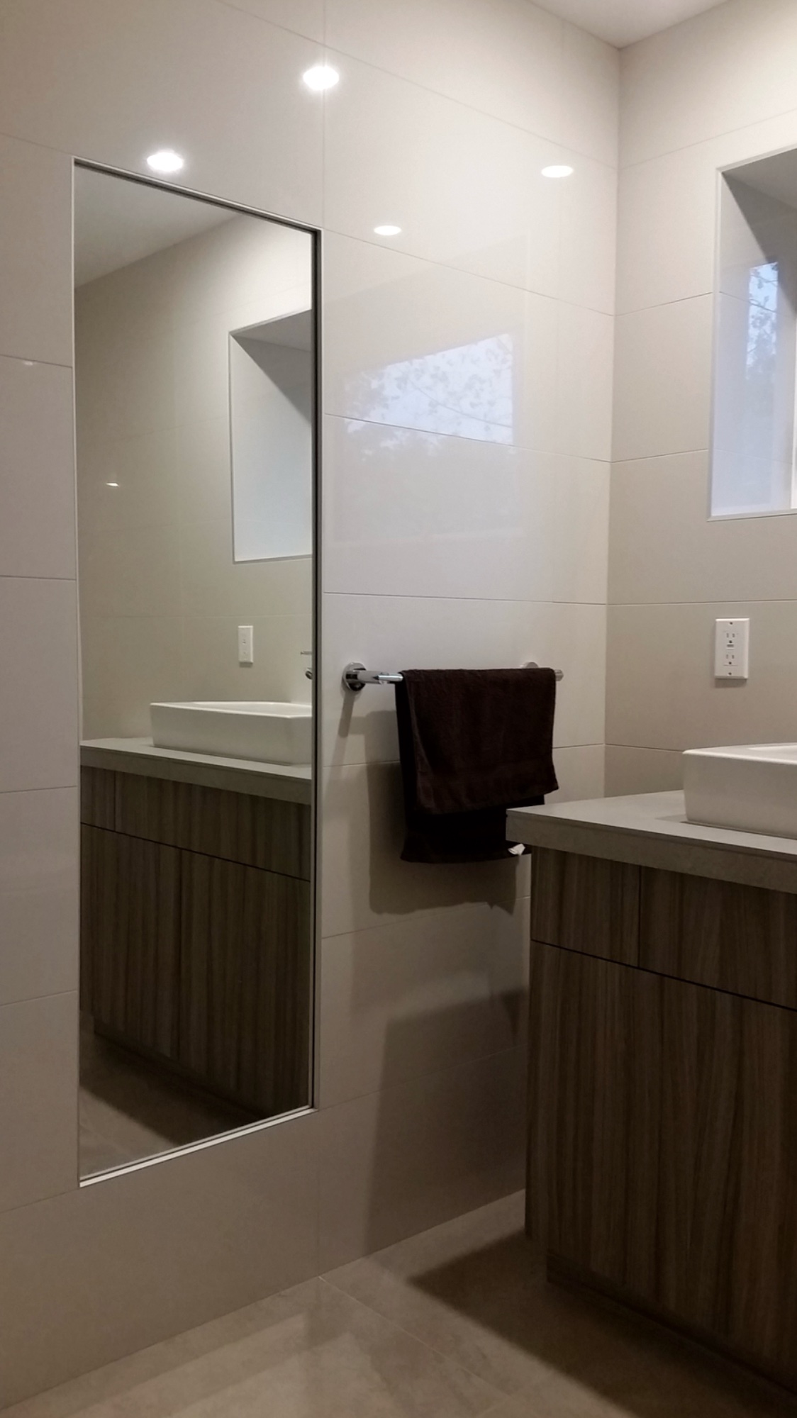 Floor to ceiling tile with inset mirror